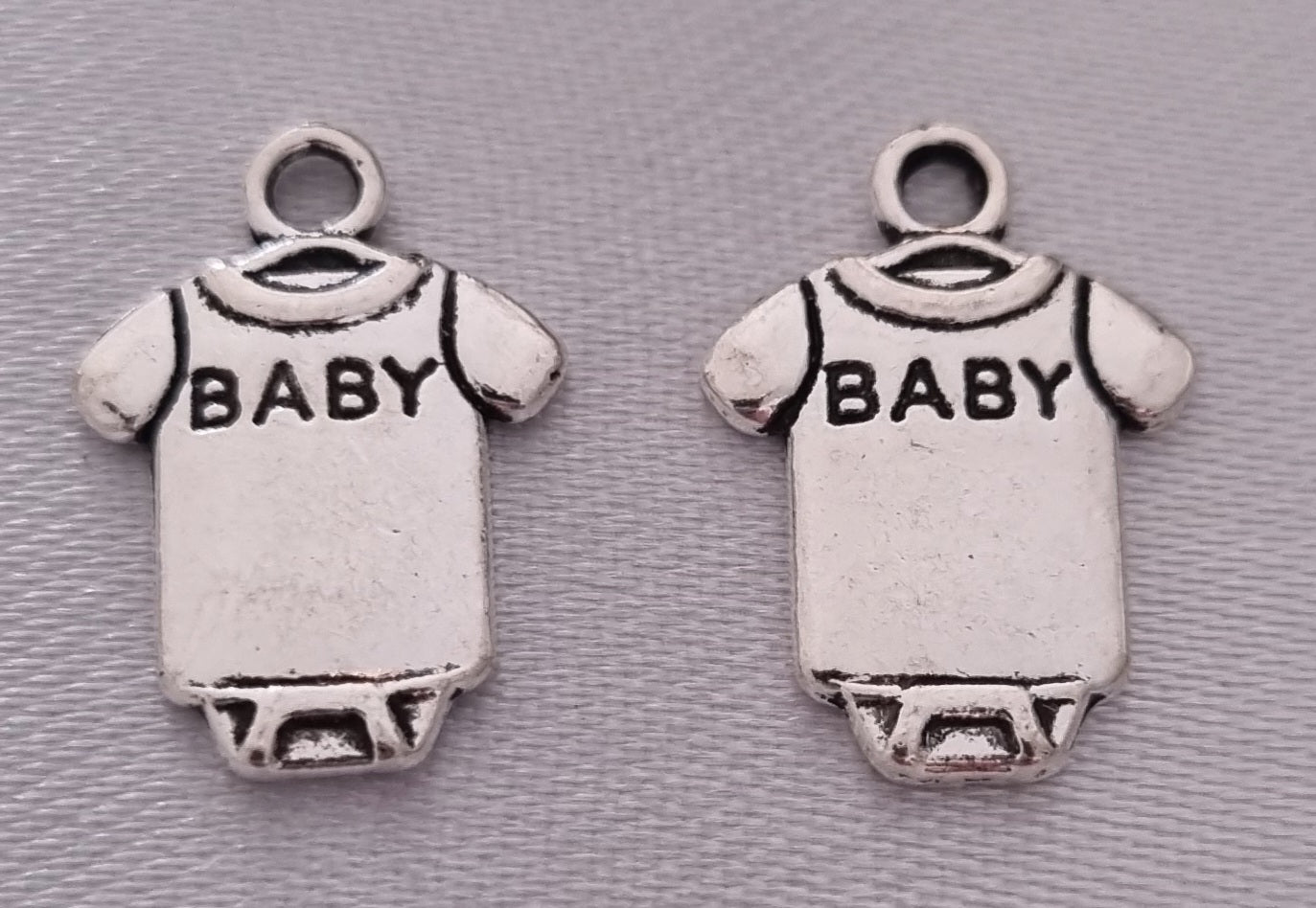Silver plated baby onsie charm, front side