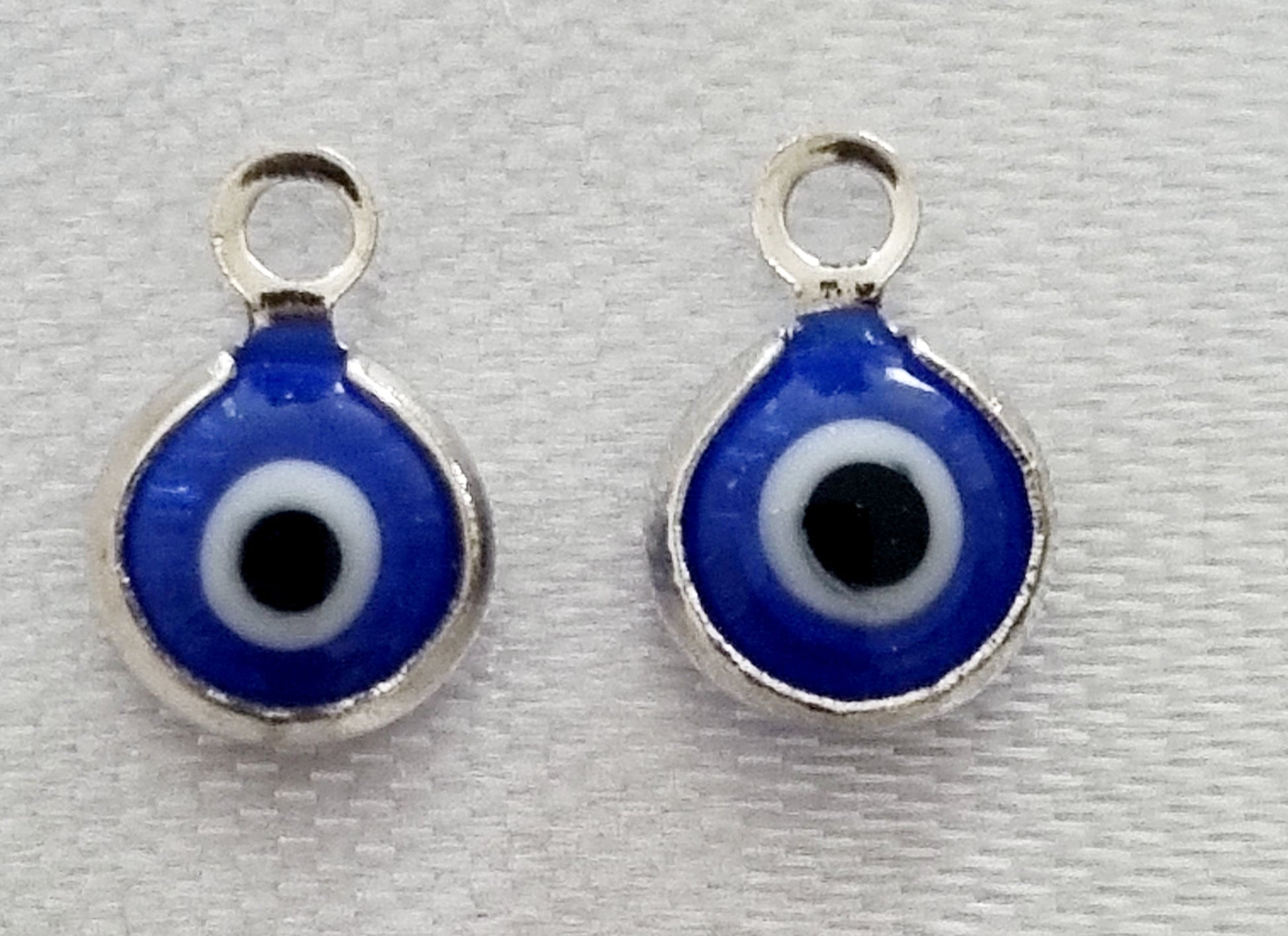 Silver plated mini round evil eye charm, front side