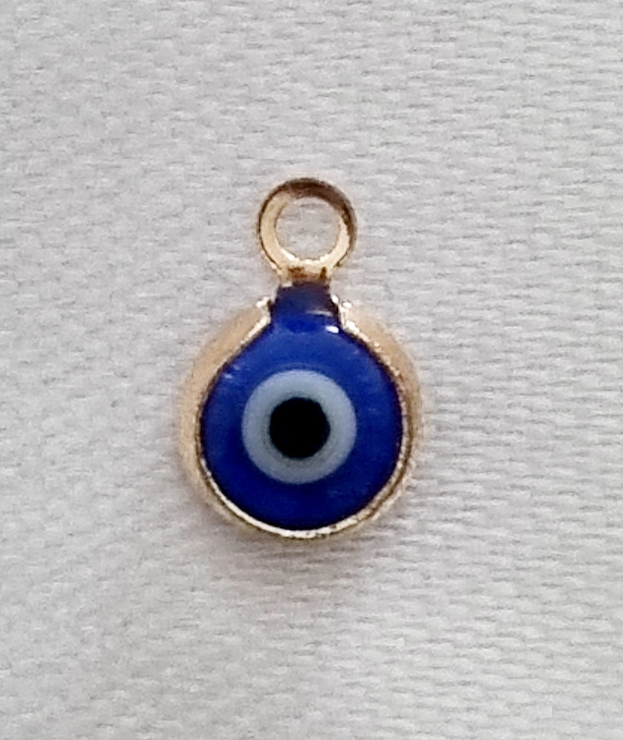 Gold plated mini evil eye charm, front side