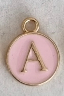 Gold plated double-sided pink enamel letter charm, front side